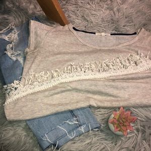 Small beige shirt. Fringe on bottom